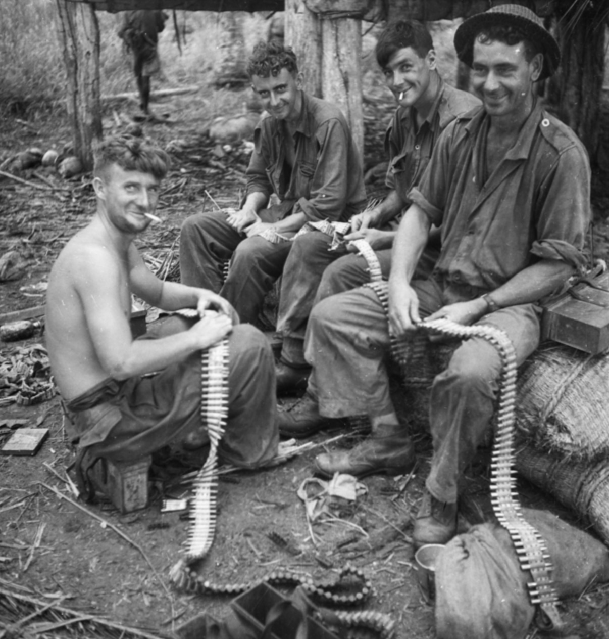 Vickers machine gunners reloading belts following the fall of Gona. 